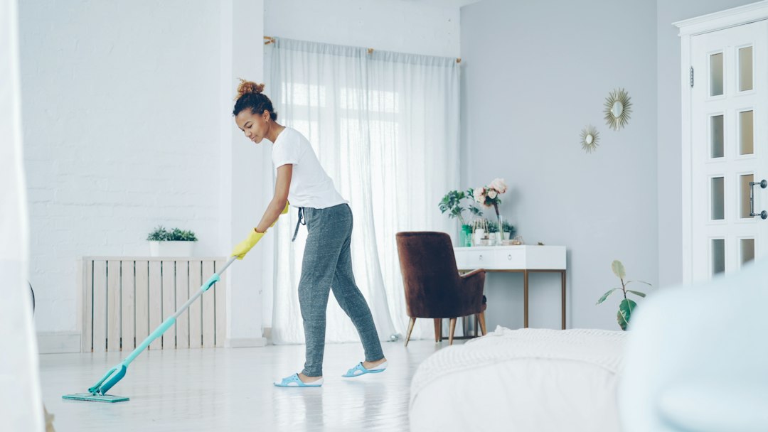 Professional cleaner mopping a modern home